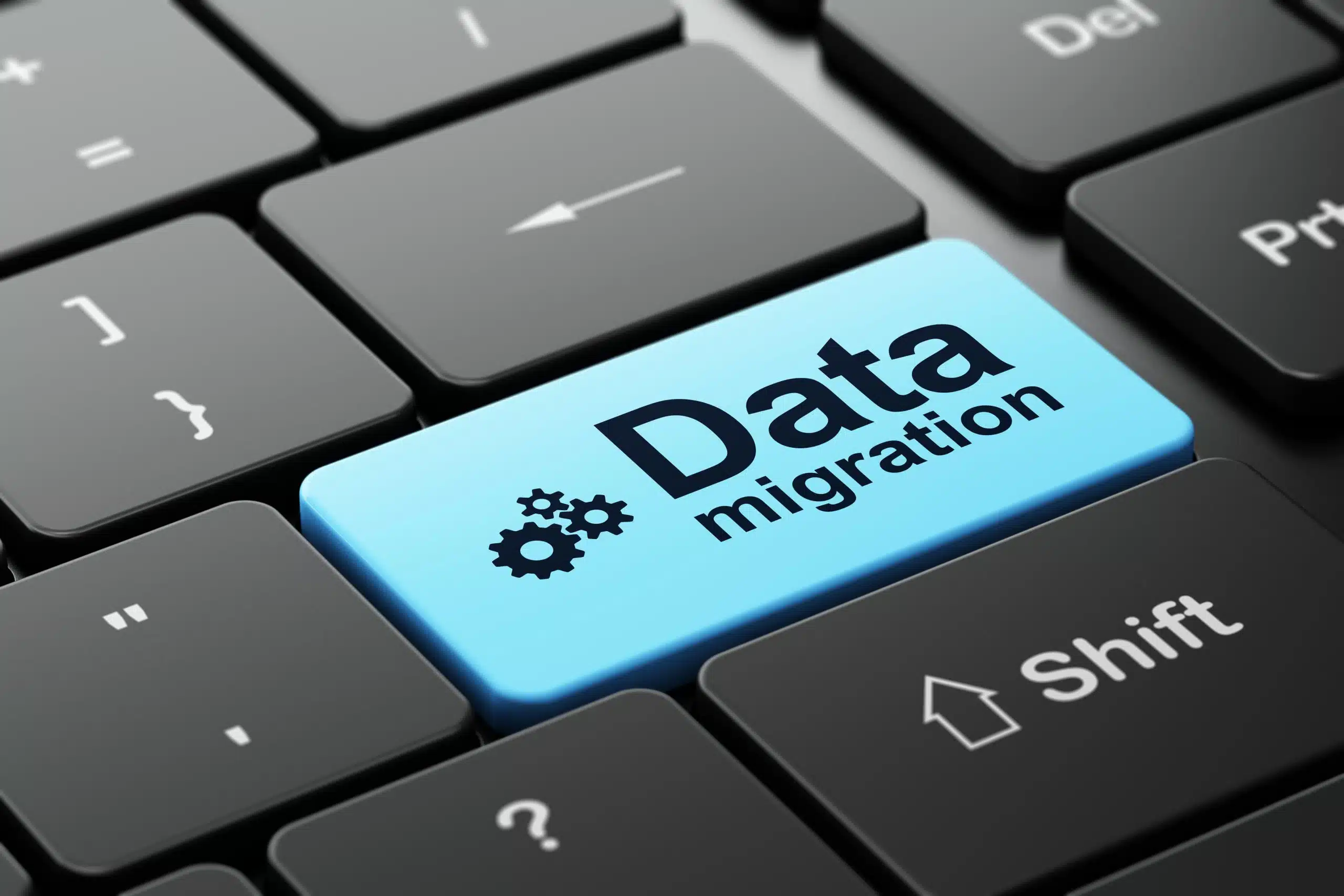 Information concept: Gears and Data Migration on computer keyboa - WeDoBack